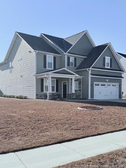 view of front of house with a porch and a garage