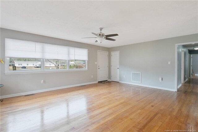 unfurnished room with ceiling fan, plenty of natural light, and light hardwood / wood-style floors