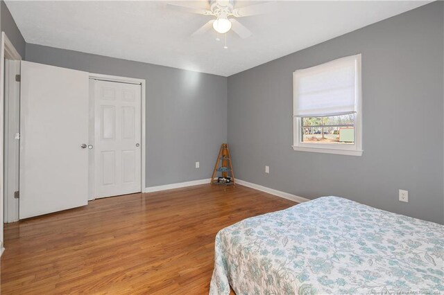 bedroom with hardwood / wood-style floors and ceiling fan