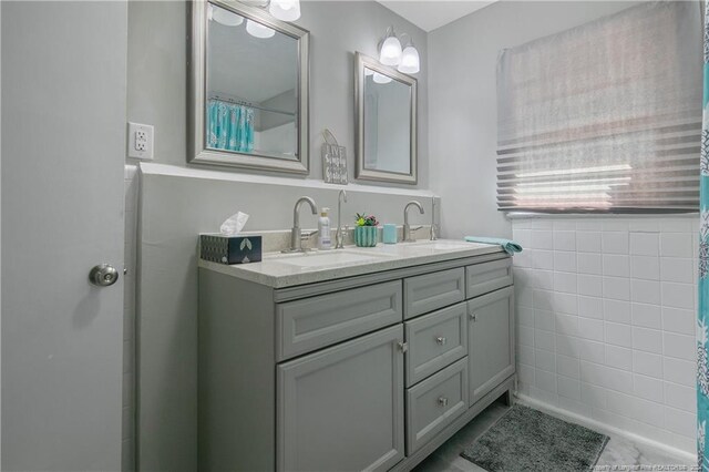 bathroom featuring vanity, tile patterned floors, and tile walls