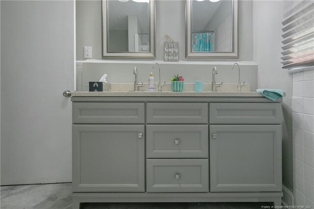 bathroom featuring vanity, tile walls, and concrete floors