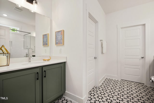 bathroom with vanity and a shower with door