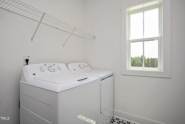 clothes washing area with washer and clothes dryer