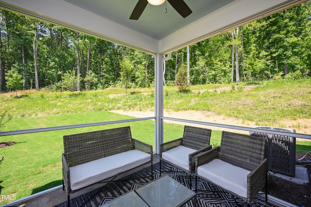 sunroom with ceiling fan and plenty of natural light