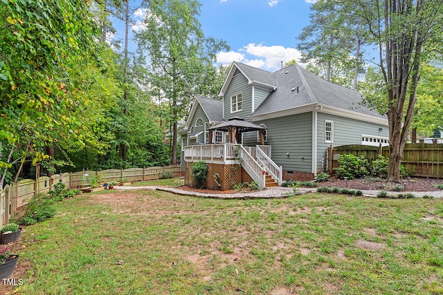 view of side of home with a gazebo, a lawn, and a wooden deck