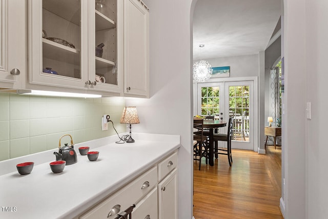 kitchen featuring white cabinets, light hardwood / wood-style floors, and pendant lighting