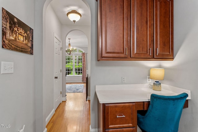 office area featuring light hardwood / wood-style floors and built in desk