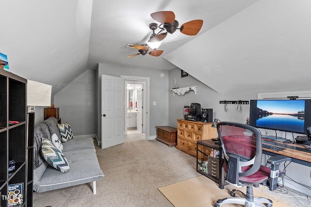 carpeted office space with ceiling fan and vaulted ceiling