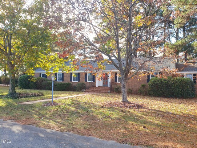 203 Green St, Fremont, NC 27830 - view of front of home with brick siding and a front yard
