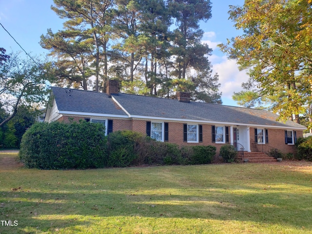 203 Green St, Fremont, NC 27830 - ranch-style home featuring a chimney, brick siding, and a front lawn