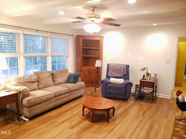 living room featuring hardwood / wood-style flooring, ceiling fan, ornamental molding, and beamed ceiling