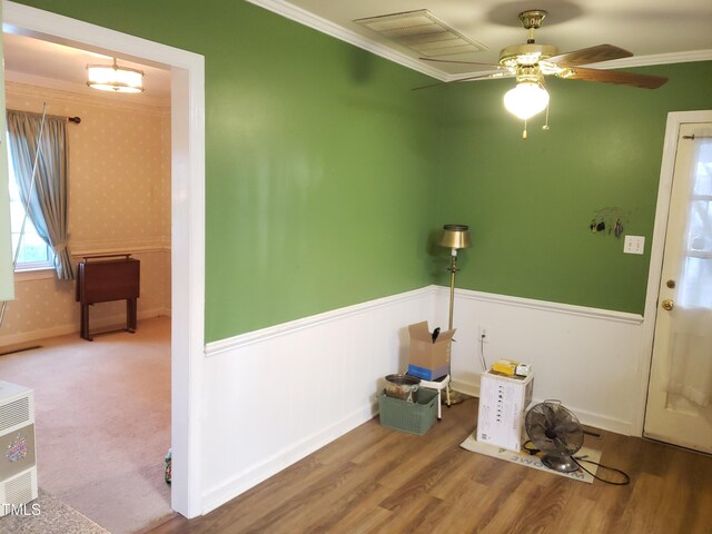 203 Green St, Fremont, NC 27830 - foyer entrance with crown molding, a wainscoted wall, wallpapered walls, wood finished floors, and a ceiling fan