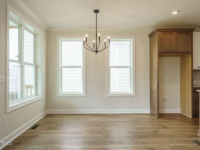 unfurnished dining area with ornamental molding, light hardwood / wood-style flooring, and a healthy amount of sunlight