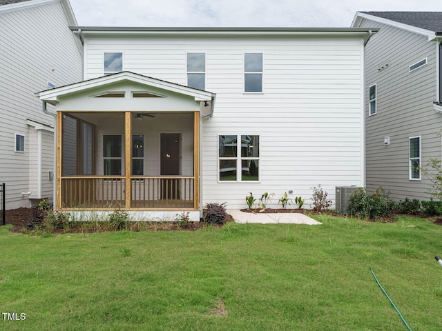 back of property featuring a sunroom, a yard, and central AC