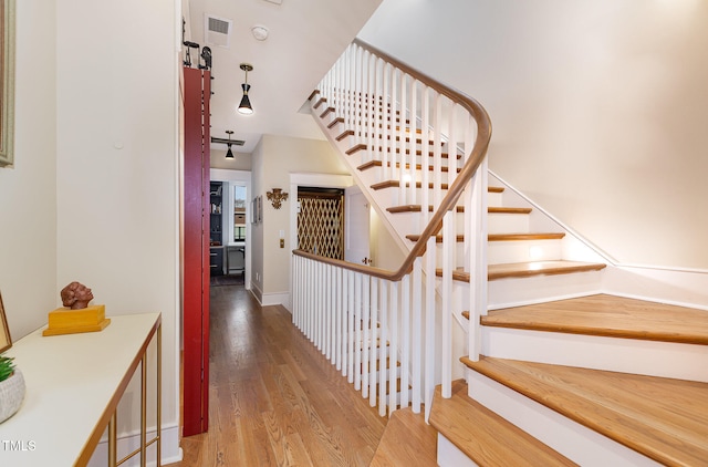 stairs with hardwood / wood-style floors