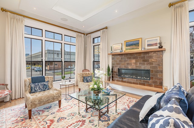 living room featuring hardwood / wood-style flooring and a brick fireplace