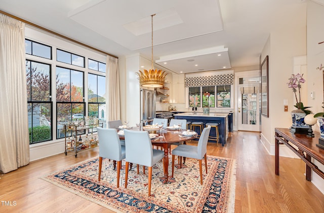 dining room with light wood-type flooring and sink