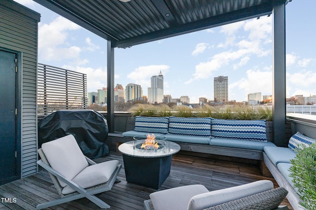 deck featuring a fire pit and a grill