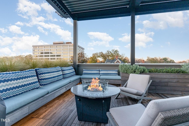 wooden deck featuring an outdoor living space with a fire pit