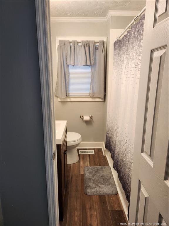 110 N Grove Ave, Rockingham, NC 28379 - bathroom featuring vanity, wood finished floors, toilet, ornamental molding, and baseboards