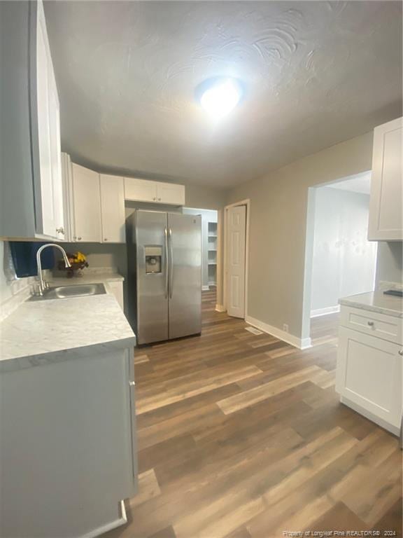 110 N Grove Ave, Rockingham, NC 28379 - kitchen with stainless steel fridge with ice dispenser, a sink, light countertops, and white cabinets