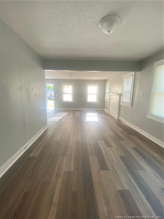 110 N Grove Ave, Rockingham, NC 28379 - hallway featuring wood finished floors, baseboards, and a textured ceiling
