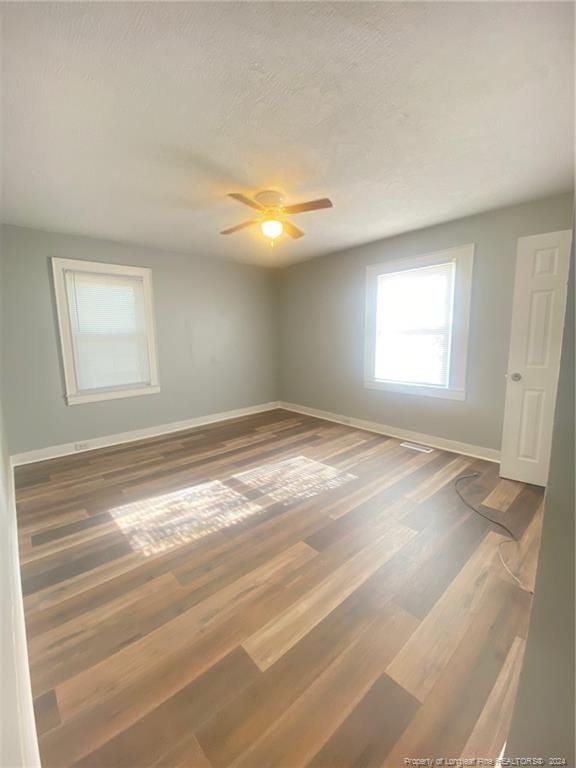 110 N Grove Ave, Rockingham, NC 28379 - empty room with baseboards, wood finished floors, and a ceiling fan