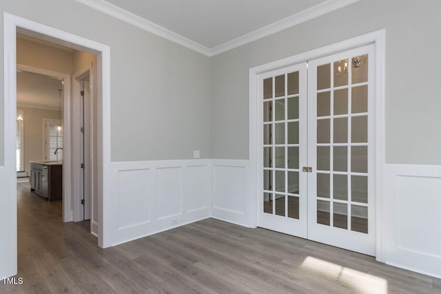 spare room with ornamental molding, french doors, and wood finished floors