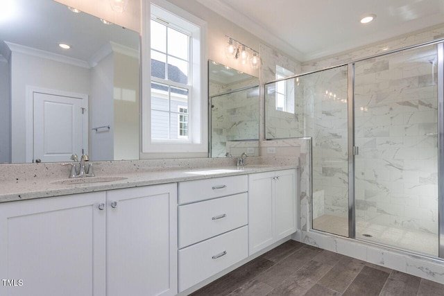 bathroom with ornamental molding, a sink, and a wealth of natural light