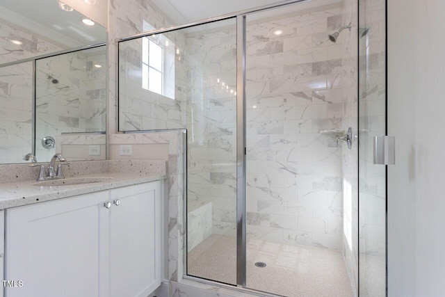 full bathroom featuring a stall shower and vanity