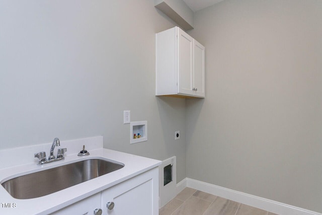 laundry area featuring cabinet space, baseboards, hookup for an electric dryer, washer hookup, and a sink