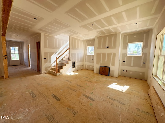 unfurnished living room with stairway