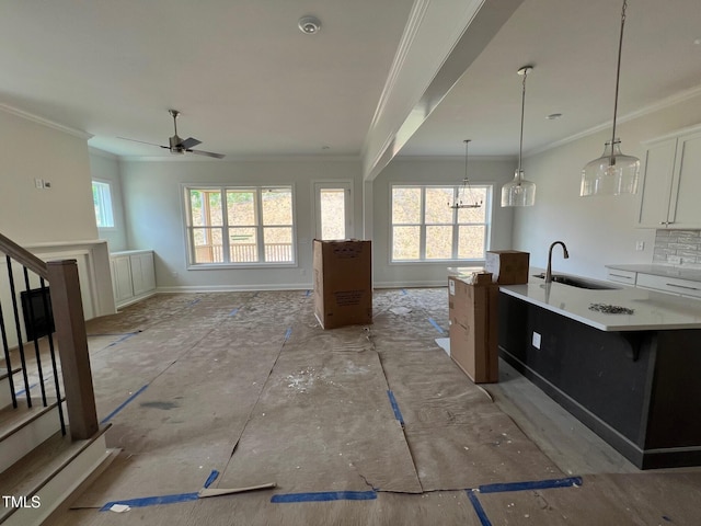 6044 Scalybark Rd, Durham, NC 27712 - kitchen featuring a sink, ornamental molding, a ceiling fan, open floor plan, and white cabinets