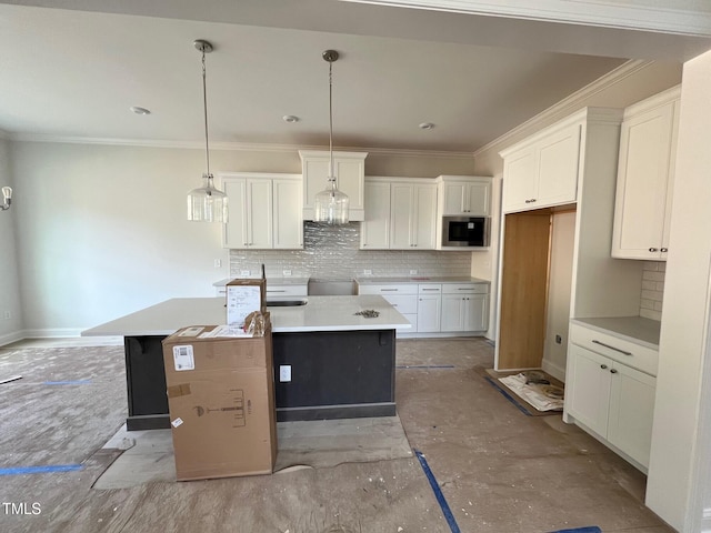 6044 Scalybark Rd, Durham, NC 27712 - kitchen featuring ornamental molding, a center island, backsplash, and white cabinetry