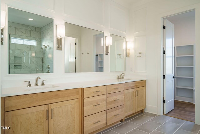 bathroom featuring tile patterned floors, vanity, and walk in shower