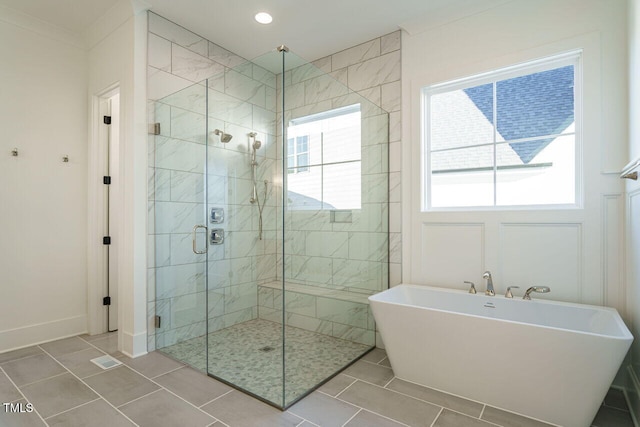 bathroom featuring tile patterned flooring and shower with separate bathtub