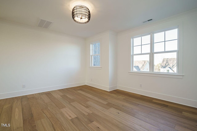 spare room with wood-type flooring and crown molding