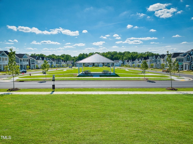 view of community featuring a gazebo, a residential view, and a yard