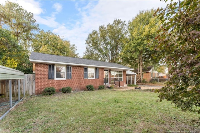 ranch-style home featuring a front yard and a carport