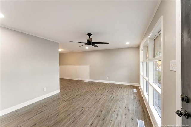 unfurnished room featuring ceiling fan, hardwood / wood-style floors, and ornamental molding