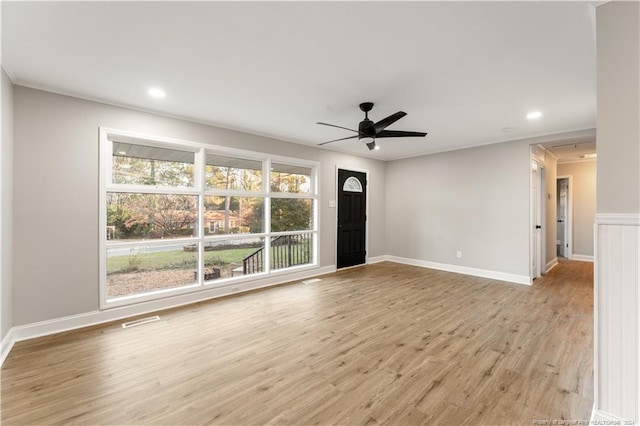 unfurnished living room featuring ceiling fan and light hardwood / wood-style flooring