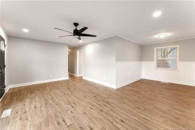 empty room featuring crown molding, ceiling fan, and light hardwood / wood-style floors