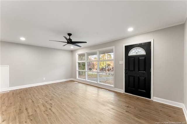 foyer entrance with hardwood / wood-style floors and ceiling fan