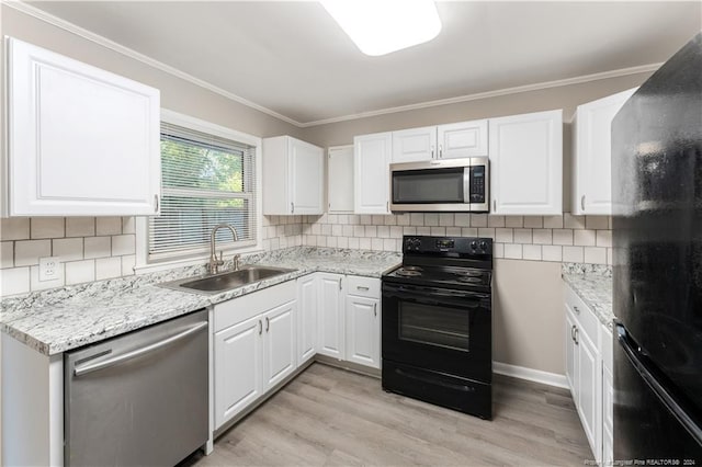 kitchen featuring sink, white cabinets, black appliances, and light hardwood / wood-style floors