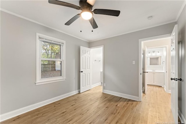 unfurnished bedroom with ensuite bath, ceiling fan, crown molding, and light wood-type flooring