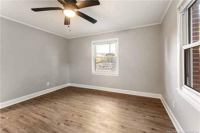 empty room with ceiling fan, hardwood / wood-style floors, and crown molding