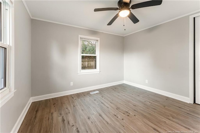 unfurnished room with ceiling fan, wood-type flooring, and ornamental molding