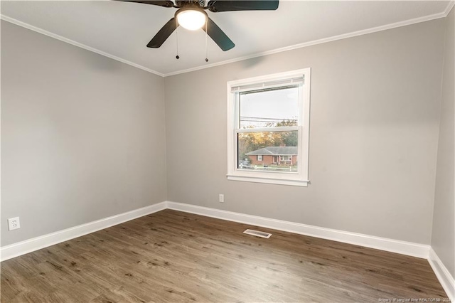 empty room with dark hardwood / wood-style floors, ceiling fan, and ornamental molding