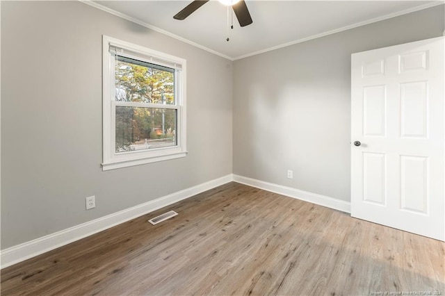 empty room with light wood-type flooring, ceiling fan, and crown molding