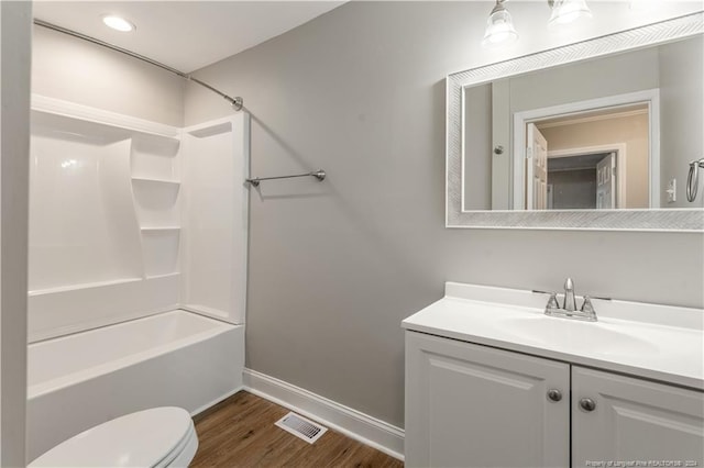 full bathroom with toilet, shower / washtub combination, vanity, and hardwood / wood-style flooring